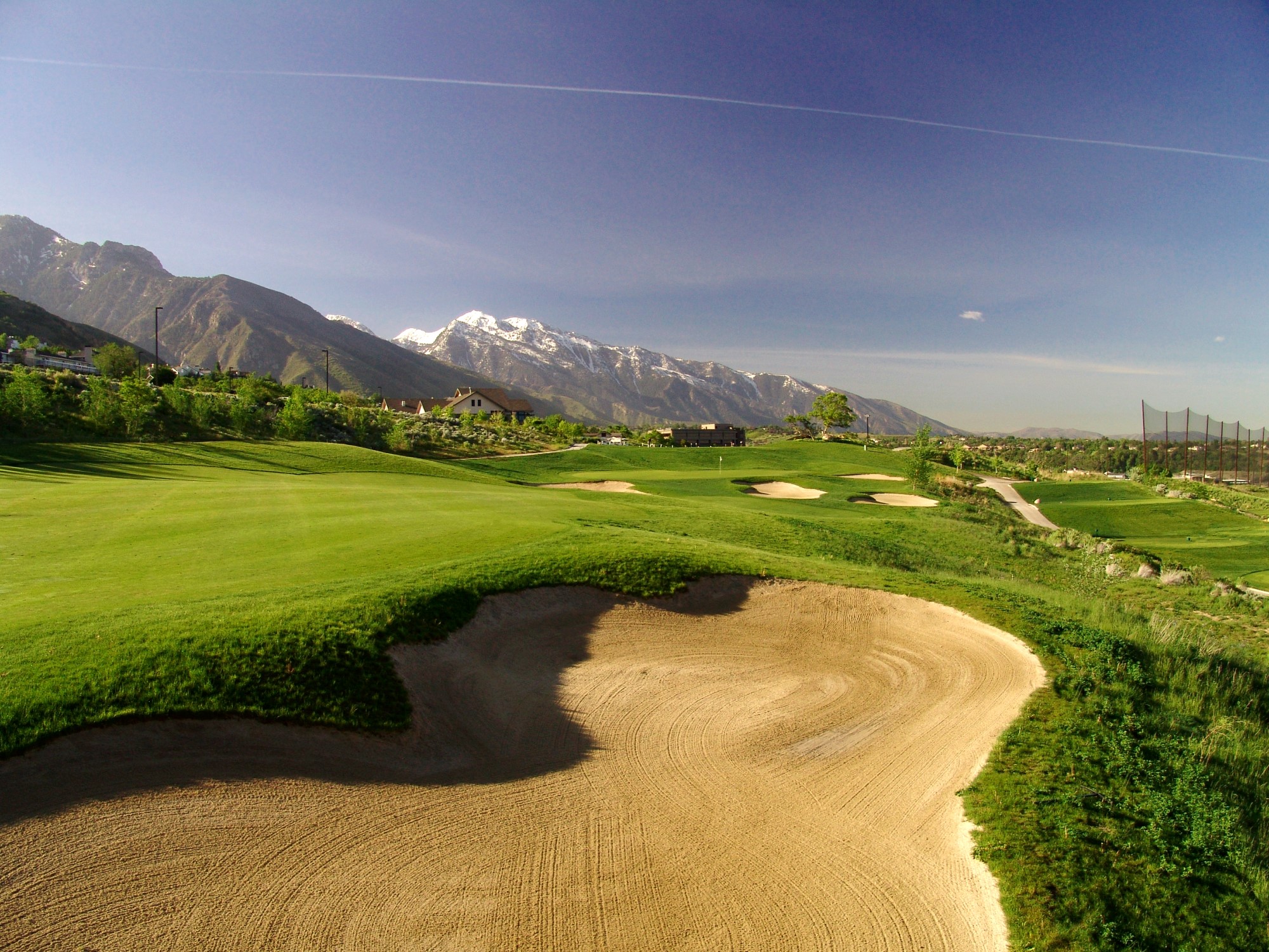 A dirt road leading to a mountain.