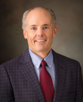 Joel Cooper in a suit and tie.