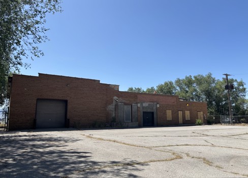 A brick building with a fence around it.