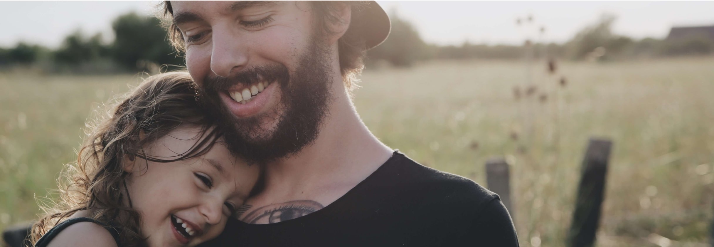 A man and woman taking a selfie in a field.