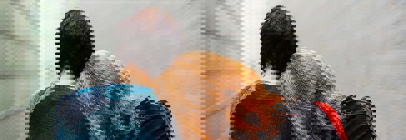 A man and woman facing each other.