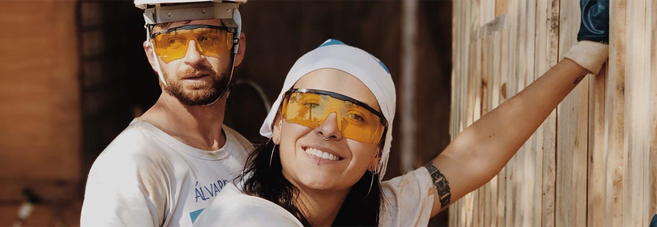 A man and woman wearing hard hats.