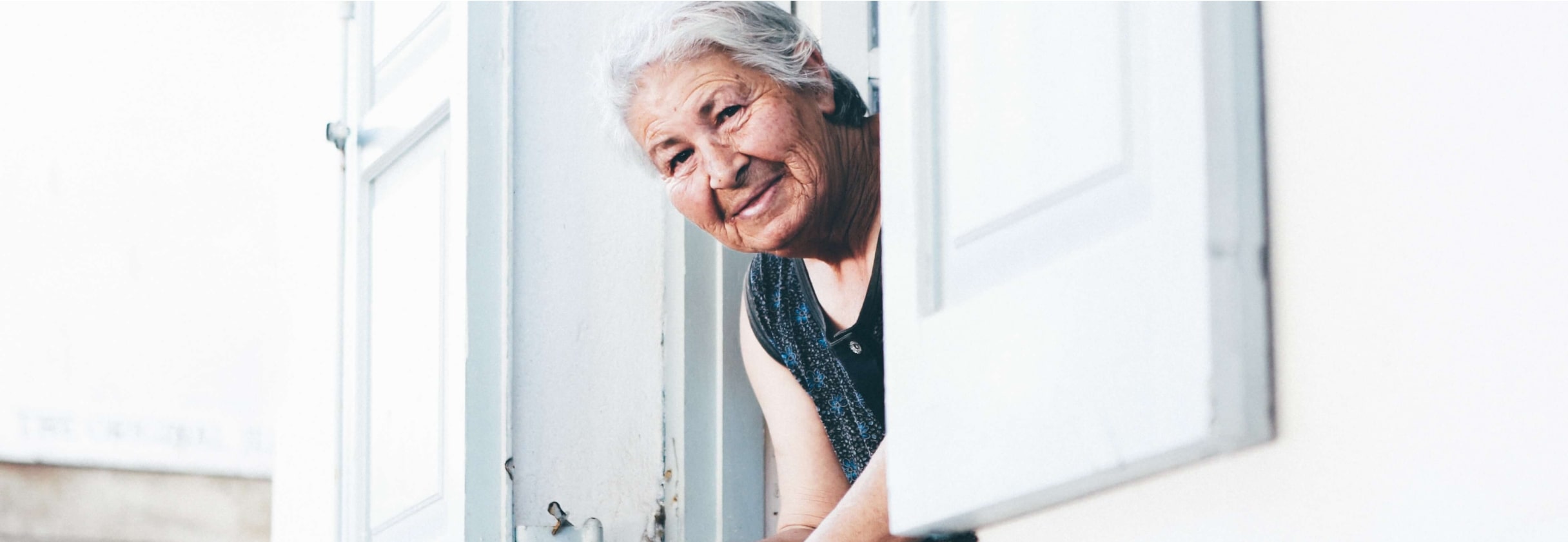 A man leaning against a door.