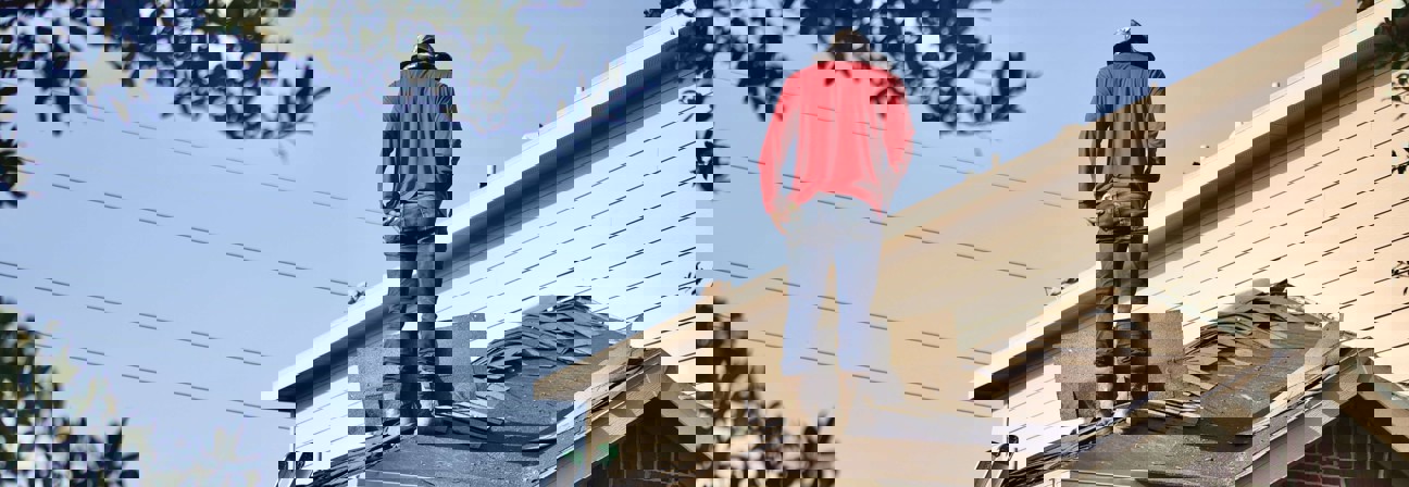 A person standing on a roof.