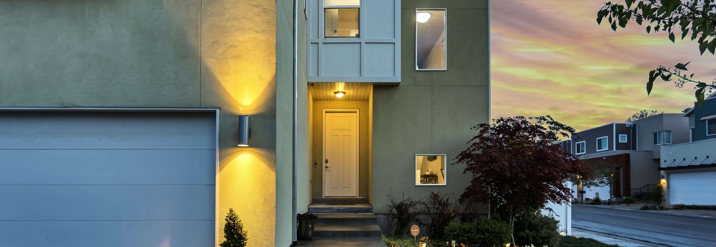 A building with a tree in front.