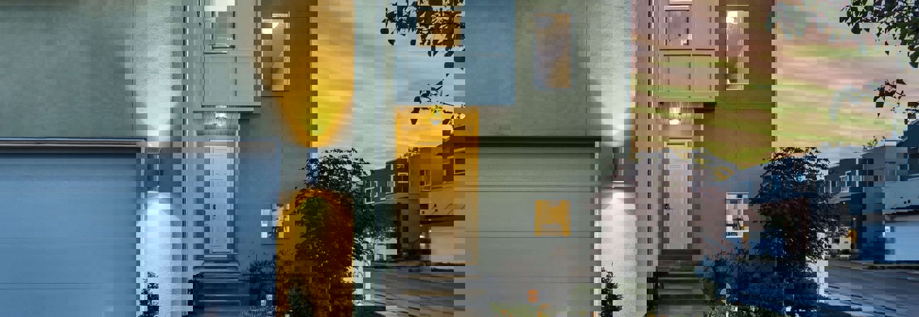 A building with a tree in front.