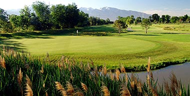 A golf course with a pond.