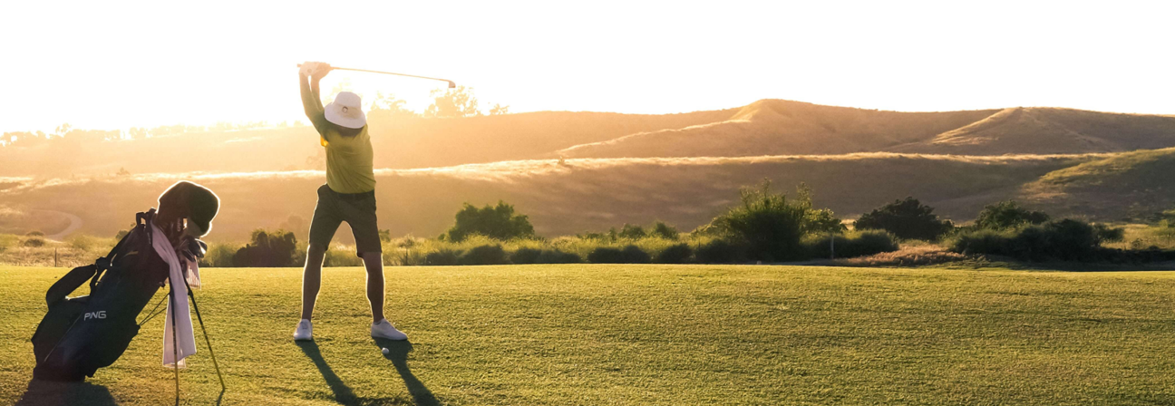 A man and a woman playing golf.