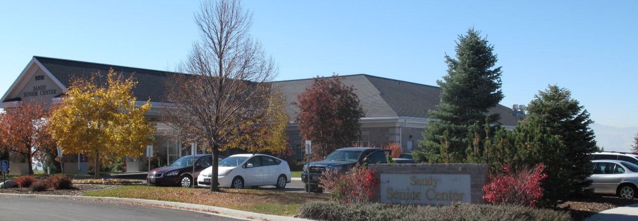 A building with cars parked in front.