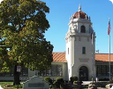 A white building with a red roof.
