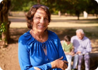 A person smiling with people in the background.