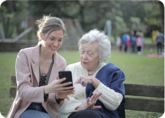 A person and a person sitting on a bench.