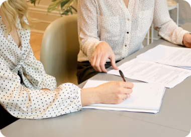 A woman writing on a piece of paper.