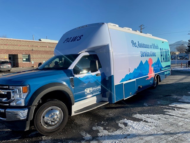 A blue truck parked in a parking lot.