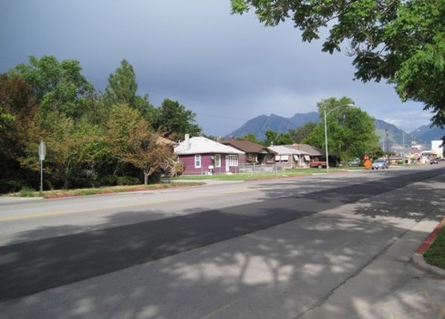 A street with houses and trees.