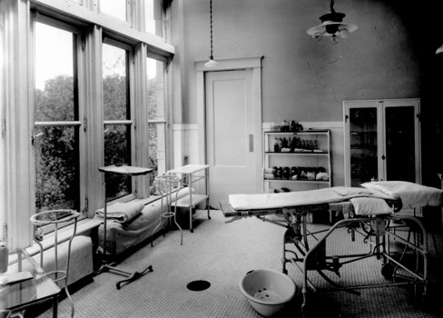 A room with a bed and tables.