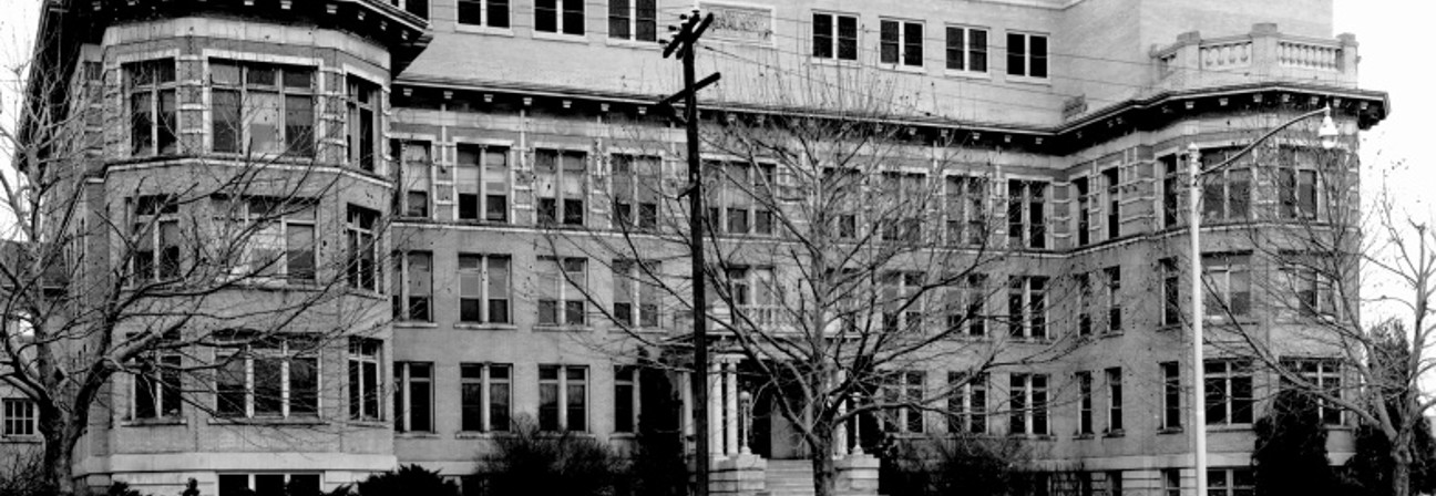 A large building with a parking lot.