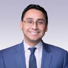 Ross I. Romero wearing a blue suit and tie.