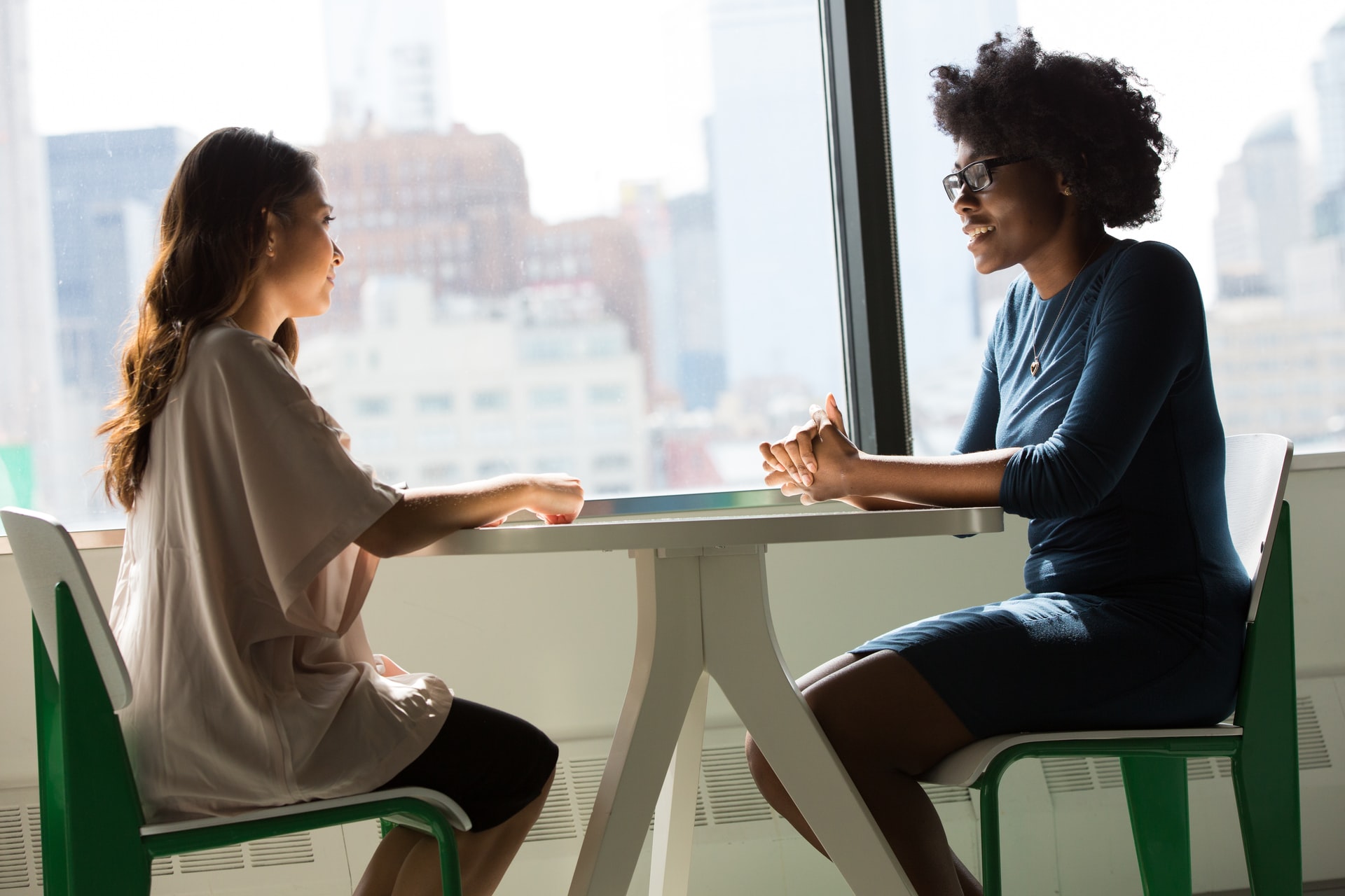 A women and a man sitting at a table talking.