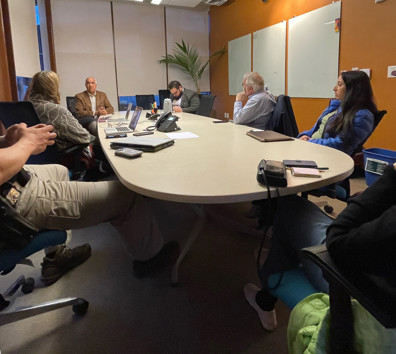 A group of people sitting around a table.