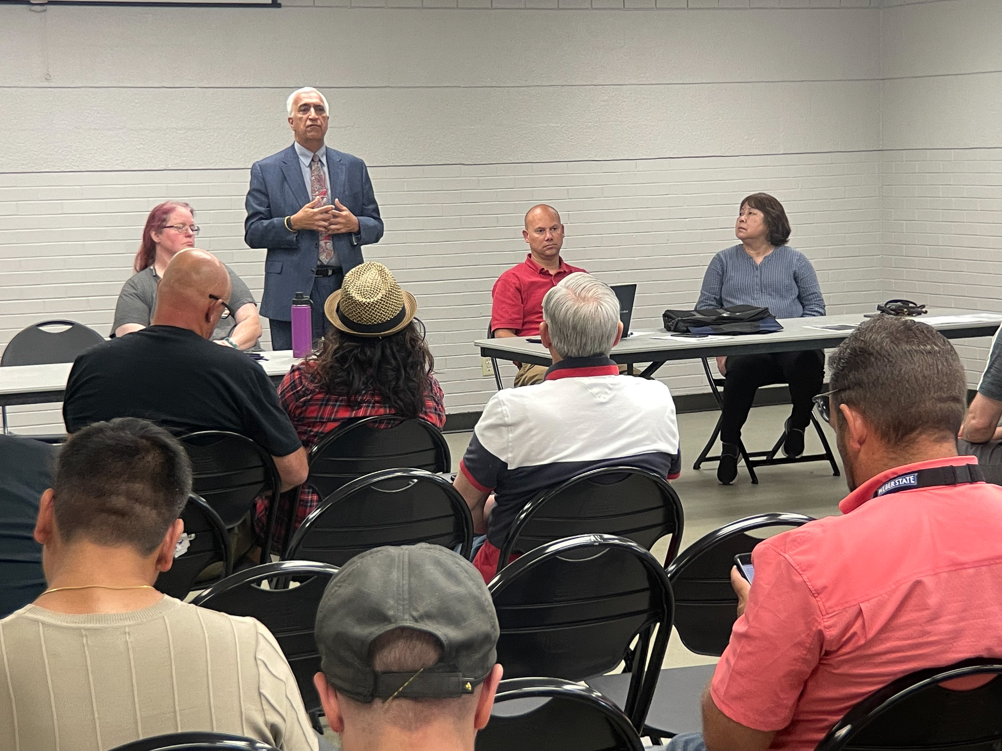 A man speaking to a group of people.