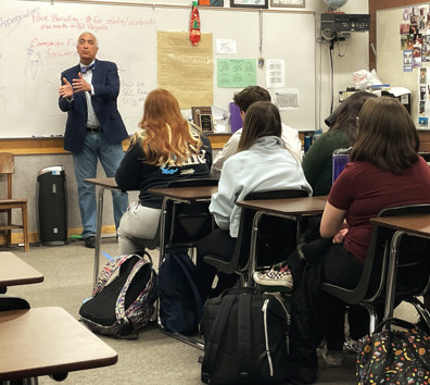 A person standing in front of a classroom of students.