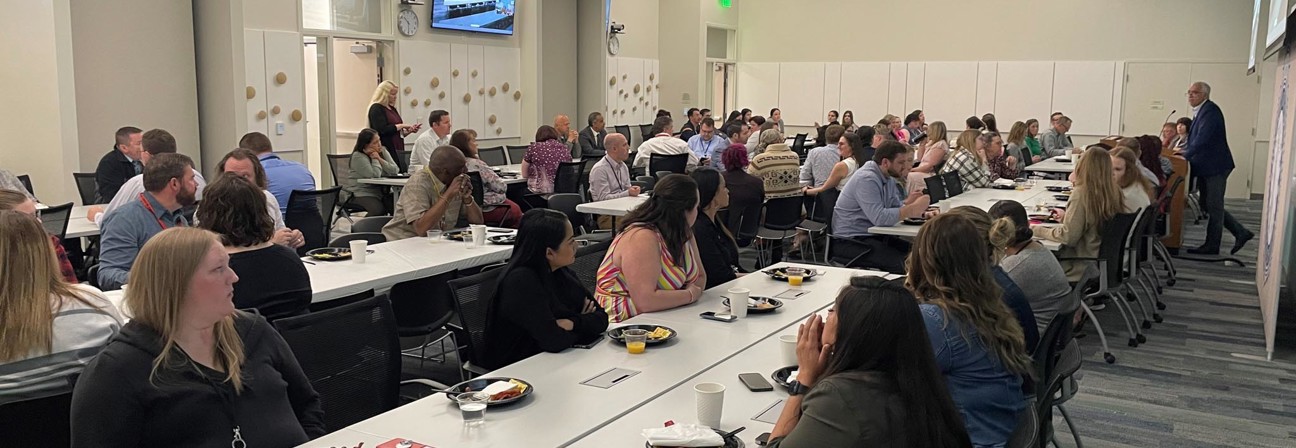 A group of people sitting at tables.