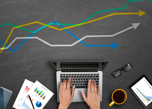 A person's feet on a laptop.