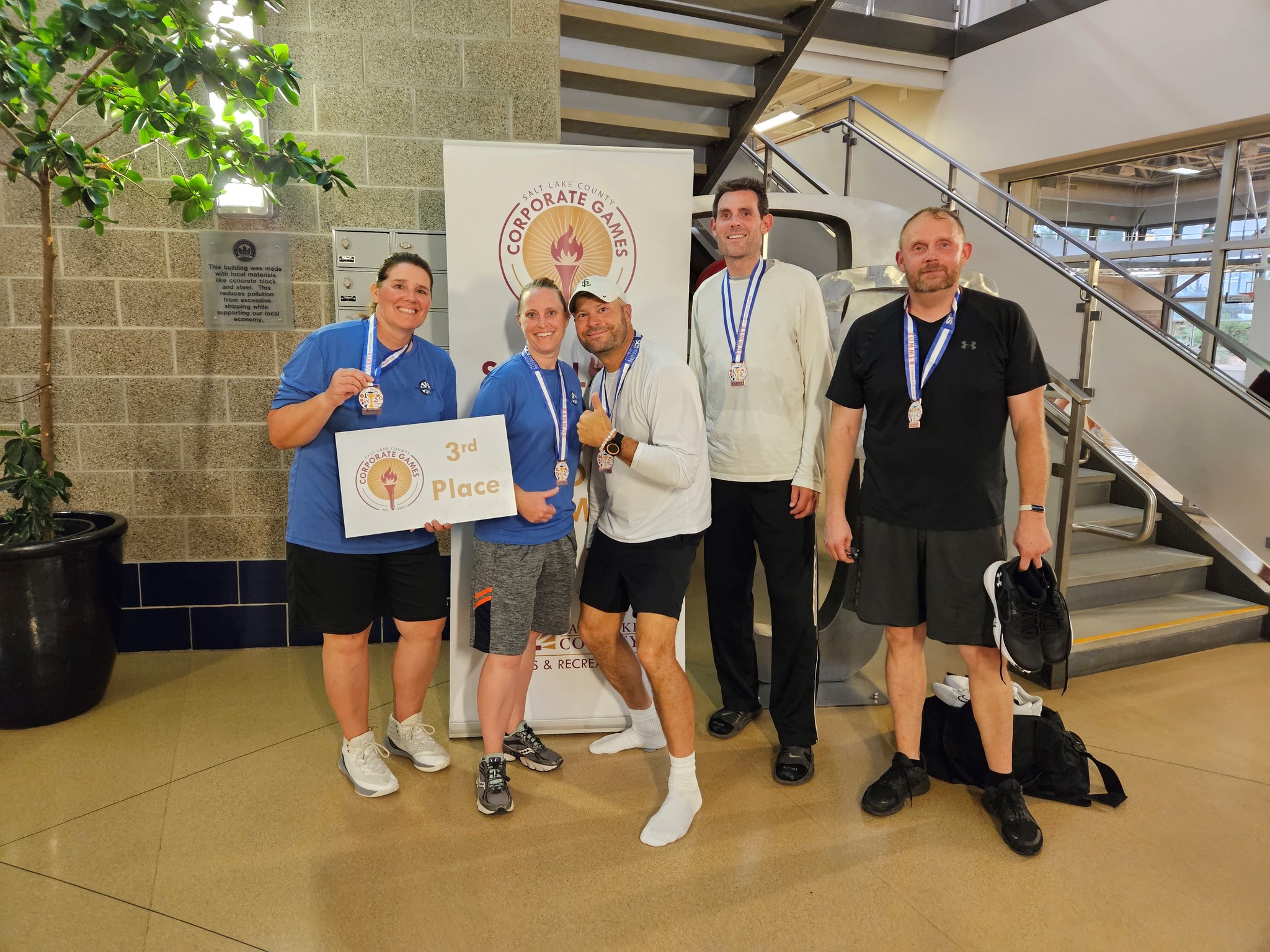 A group of men holding a sign.