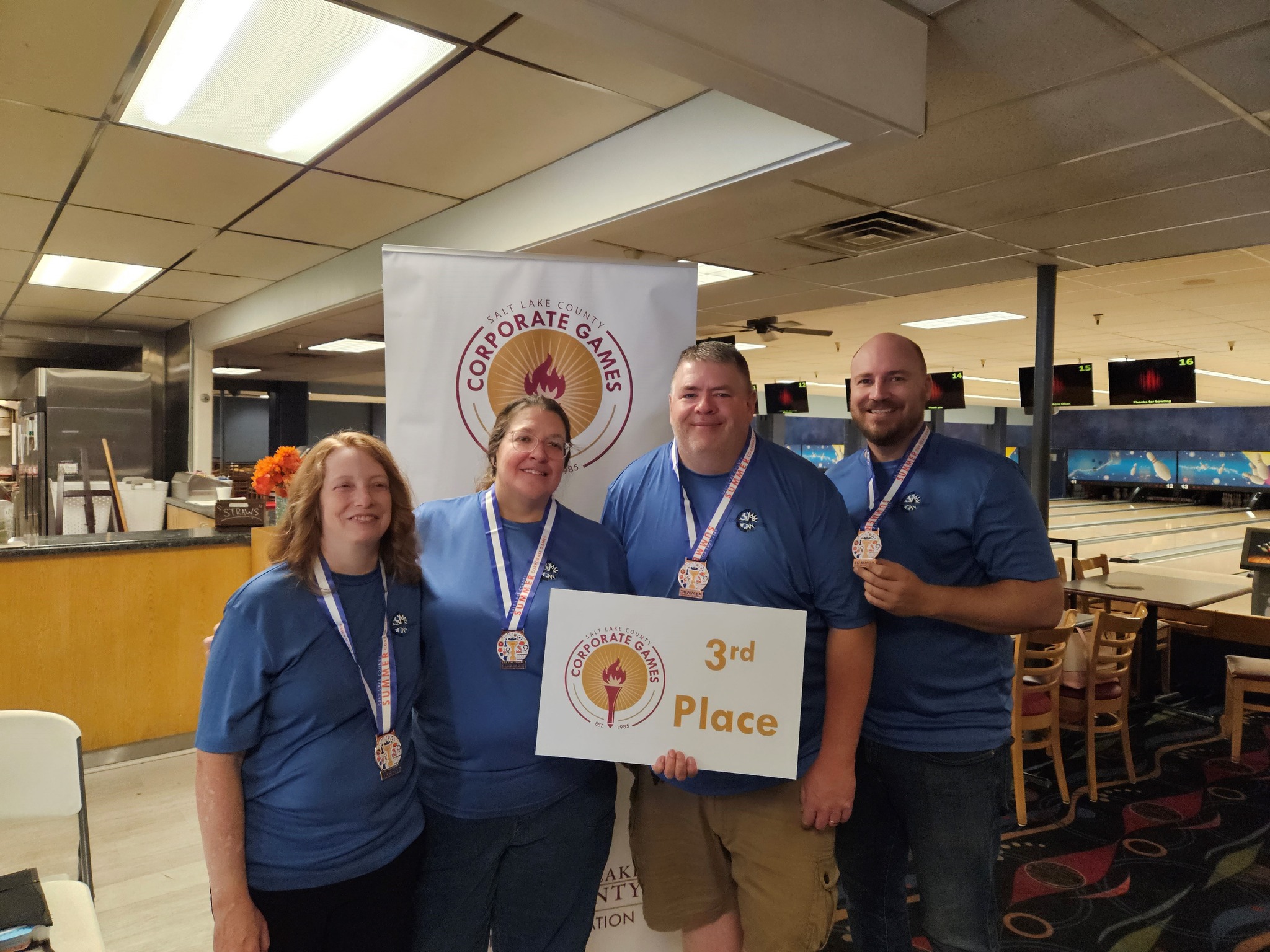 A group of people holding a sign.