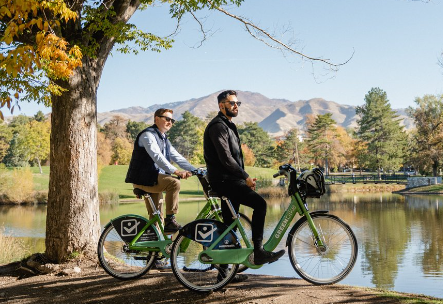 Two men on a bicycle.