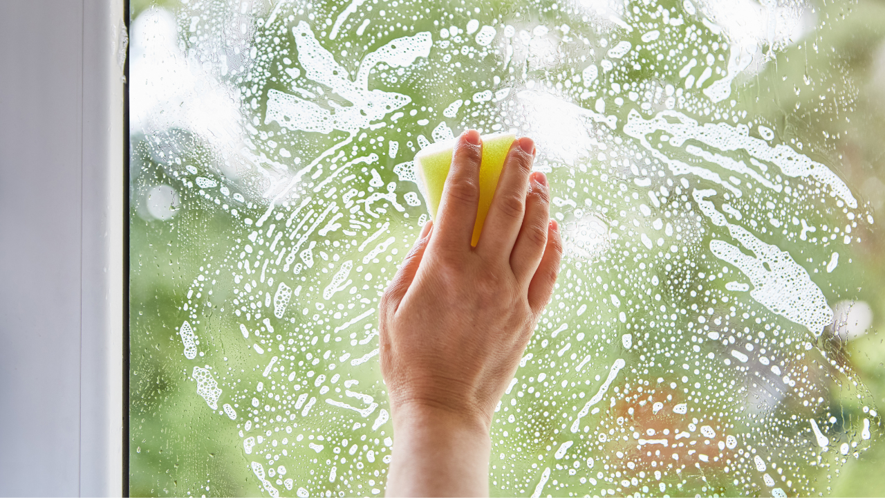 A hand on a window seal.