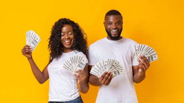 A man and woman holding a fan.