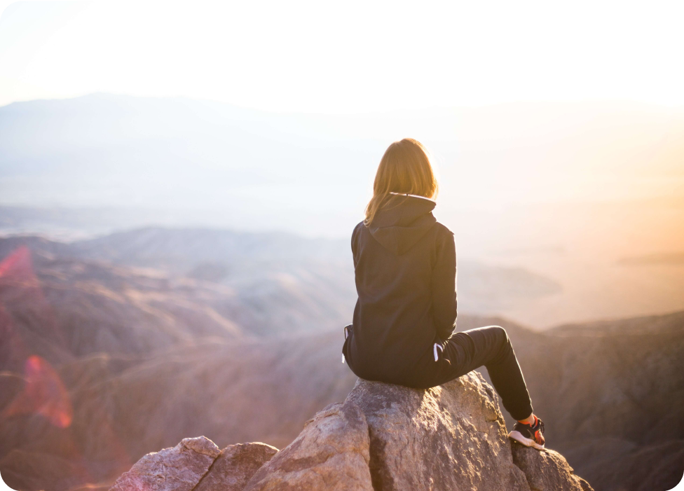 A man sitting on a rock.