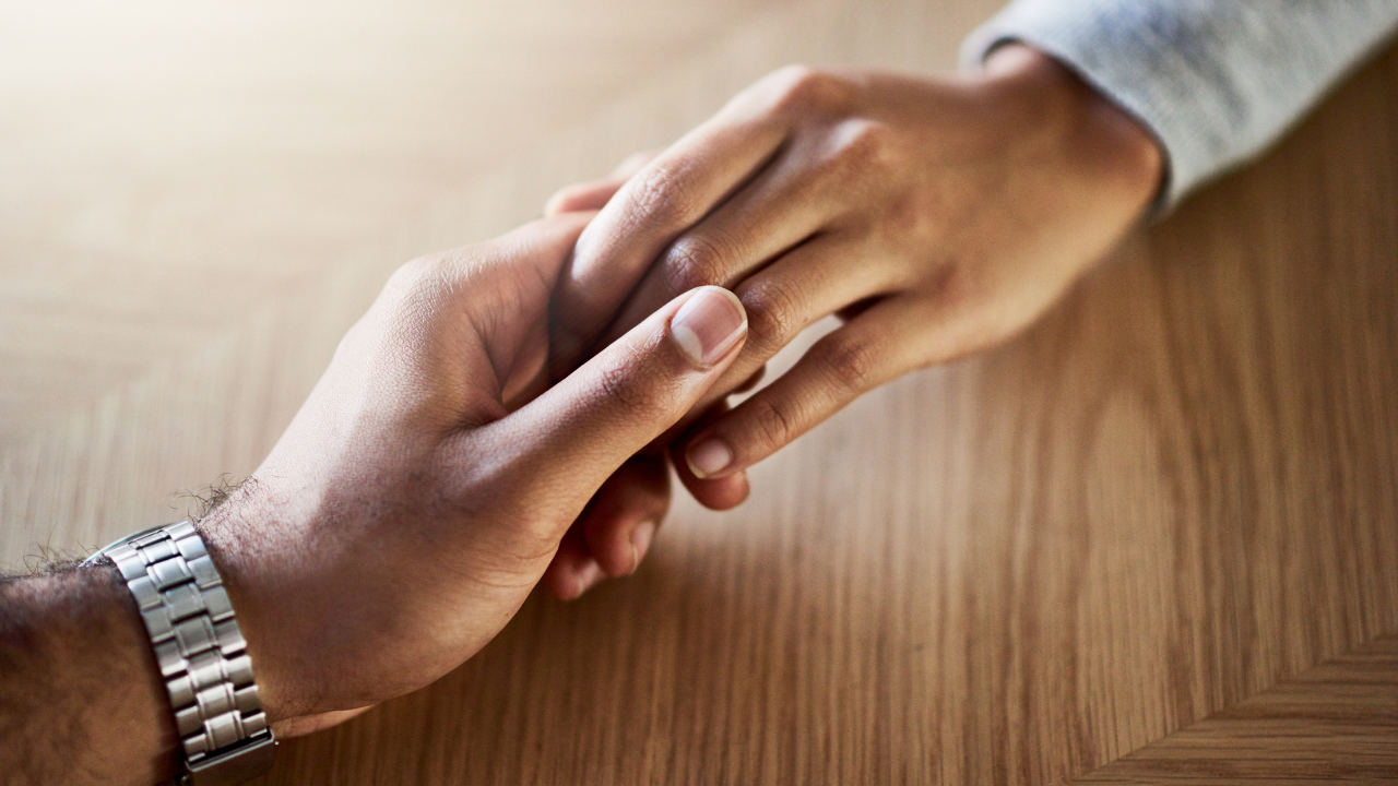 A close-up of hands shaking.