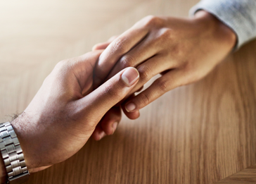 A close-up of hands shaking.