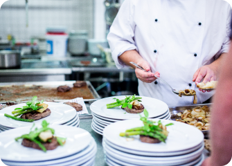 A chef preparing food in a kitchen.