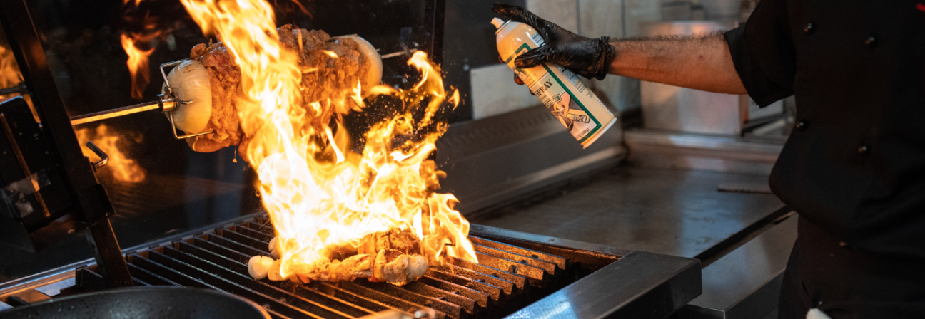 A person putting food on a grill.