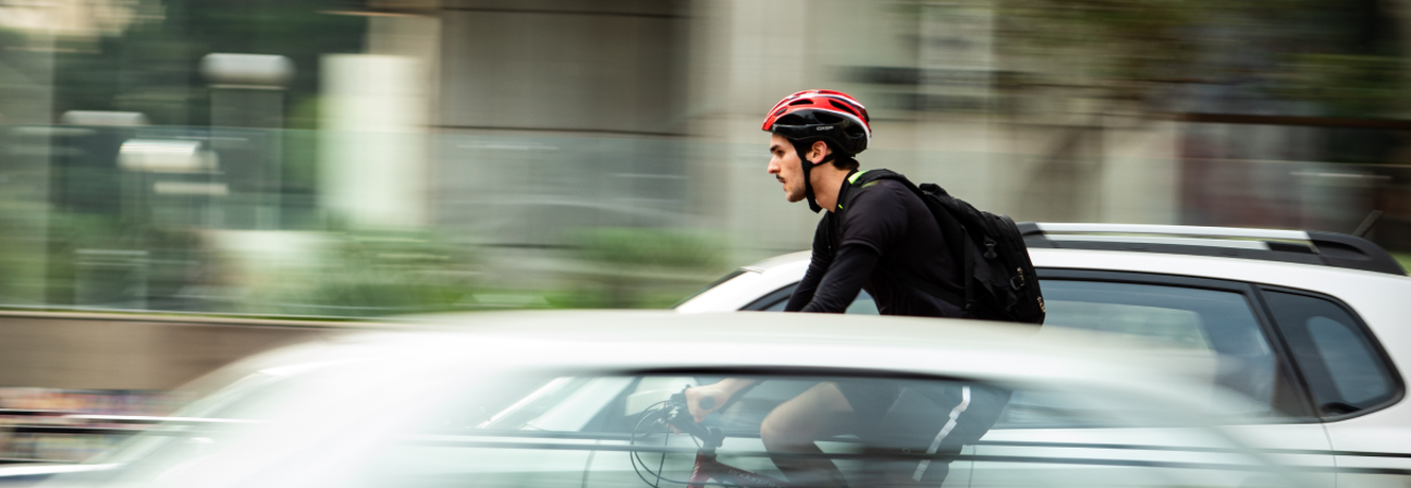 A person wearing a helmet and riding a car.