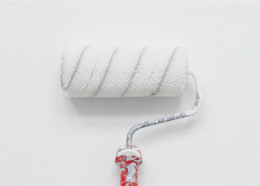 A white t-shirt with a red string tied around it.