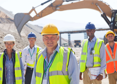 A group of men wearing safety vests and reflectors.
