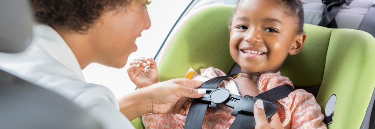 A person and a child in a car.