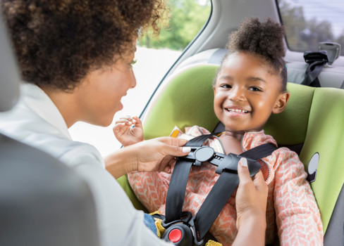 A person and a child in a car.