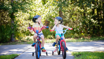 Two kids riding bikes.