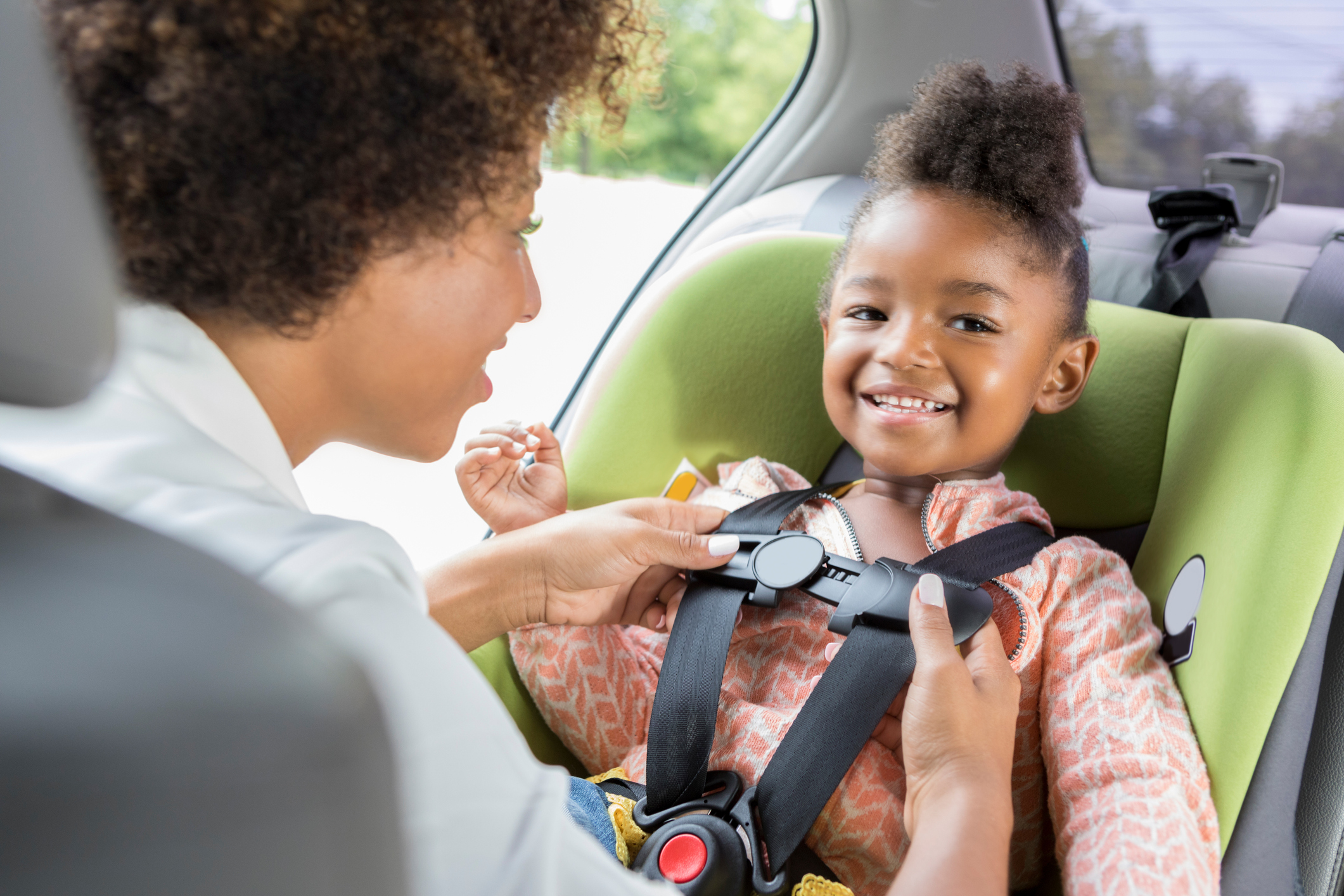 A person and a child in a car.