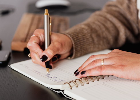 A person writing on a piece of paper.