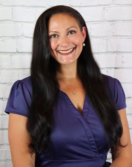 A woman smiling for the camera.