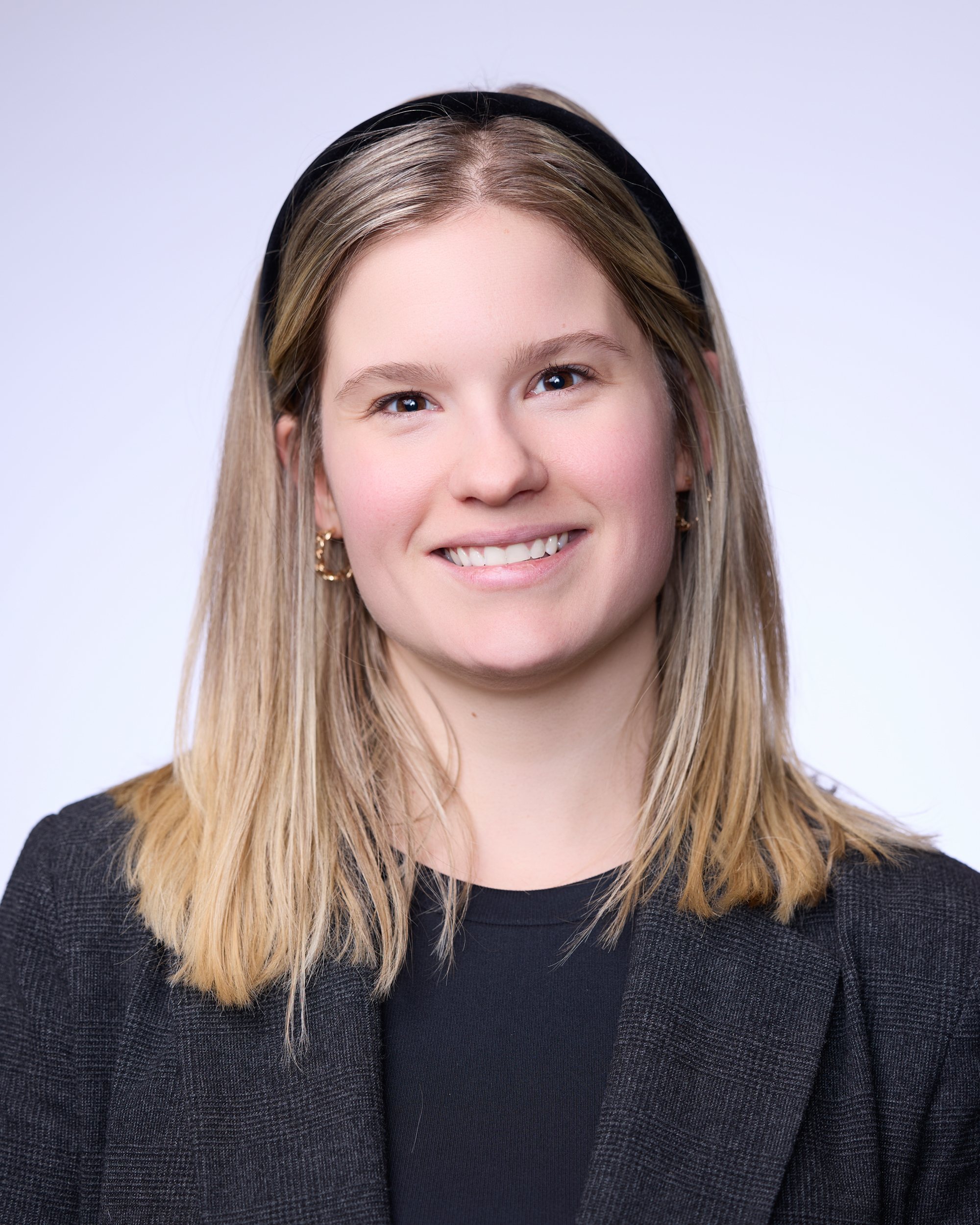 A woman with long hair smiling.