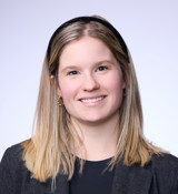 A woman with long hair smiling.