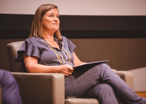 Jenny Wilson sitting on a chair.